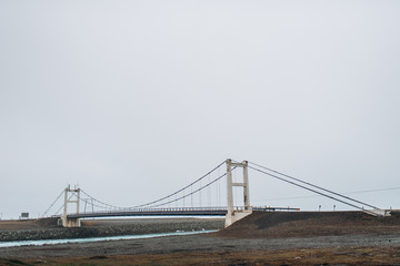 metal and concrete bridge with asphalt road