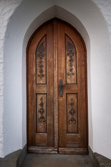 Fototapeta na wymiar Door of a small chapel on a hill near Weißensberg