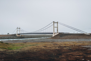 metal and concrete bridge with asphalt road