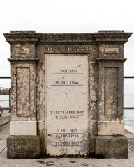 Fototapeta na wymiar Monument on the pier in Bregenz with markings of the highest floods of lake Constance