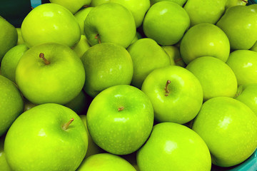A pile of green apples as background, texture (Granny Smith)