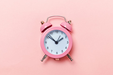 Ringing twin bell vintage classic alarm clock Isolated on pink pastel colorful trendy background....
