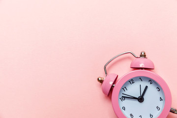 Ringing twin bell vintage classic alarm clock Isolated on pink pastel colorful trendy background....