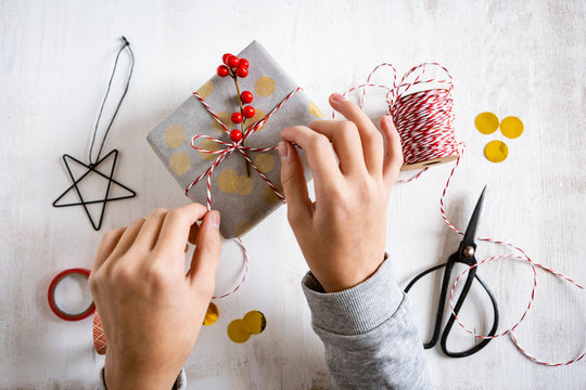 Girl's hands wrapping Christmas present
