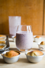 Blueberry smoothies with lactose free almond milkbanana muffins, concept for healthy breakfast and snack.