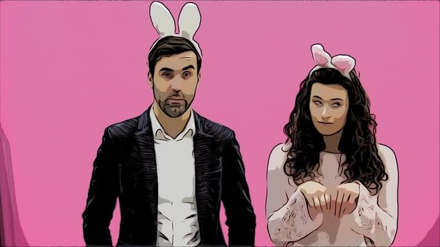 Young couple standing standing on pink background. During this time, they are dressed in rabble ears. Looking at each other smiles sincerely. Easter Concept. Animation.