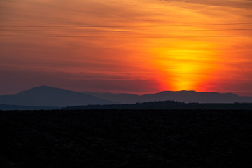 Spectacular sunset over plowed agricultural field in Southern Bulgaria