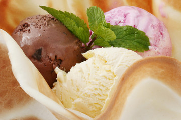 Gourmet ice-cream served in home made wafer cup. Close Up Still Life of Scoops of Chocolate, Vanilla, Berry Ice Cream. Isolated  on white background.