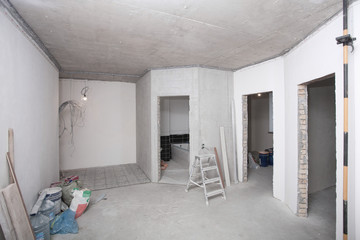 Apartment repair and plaster walls. New home. Concrete walls. Interior renovation. Tile laying. White room..