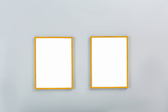 Gold frames with empty canvases on wall. Space for design