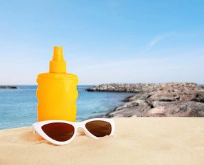 Picturesque view of beach with stone breakwater on sunny day