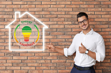 Portrait of handsome young man and space for text on brick wall background