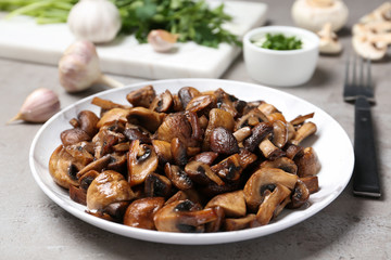 Plate of tasty fried mushrooms on table