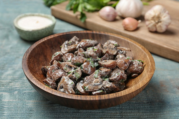 Bowl of fried mushrooms with sauce on table