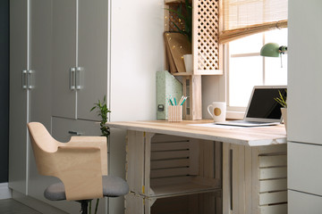 Modern home workplace with wooden crates. Eco style interior