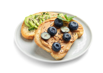 Plate of tasty toasts with avocado, blueberries and chia seeds on white background