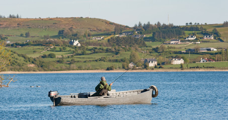 Man fishing on Loughrea Lake in County Galway, Ireland