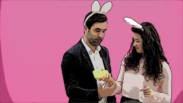 Young lovers couple on pink background. With hungry ears on the head. During this Easter photo, I made sephi on my phone and looked at them laughing. Easter .Animation.