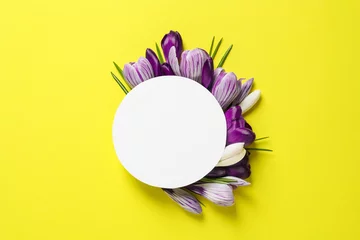 Raamstickers Beautiful spring crocus flowers and card on color background, flat lay. Space for text © New Africa