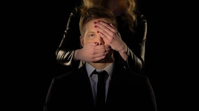 Female closing mans eyes and mouth, control and domestication in relationship
