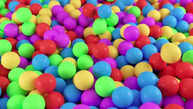 Colorful 4k 3D animation from a pile of abstract spheres and balls rolling and falling from top to bottom.
