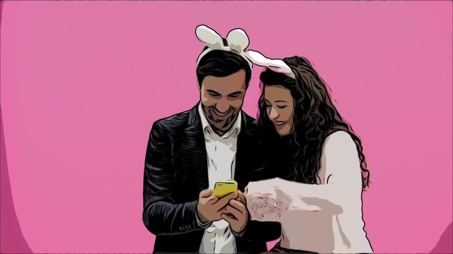 Young lovers couple on pink background. With ravenous ears on the head. During this Easter photo, I made sephi on my phone and looked at them laughing. Animation.