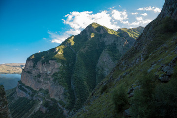 Fototapeta premium Mountains and the nature of the North Caucasus, the blue sky over high rocks in the beautiful gorge