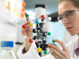 Scientist examining a drug formula design using a molecular model in the laboratory