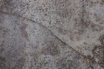 gray stone texture from dirty concrete wall with crack
