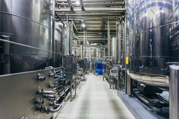 Industrial stainless steel vats in modern brewery 