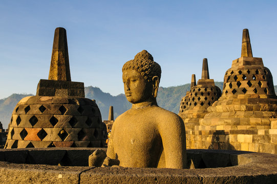 Indonesia, Java, Borobudur Temple Complex, Buddha sitting in a stupa