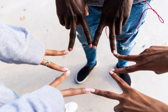 Friends touching with fingers of their hands, making a star shape