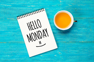 hello monday, text in notepad with turquoise wooden background