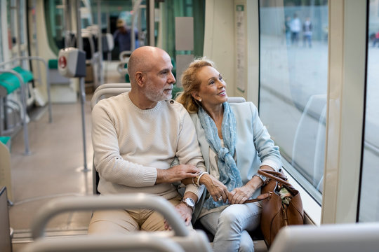 Senior couple sitting in a tram