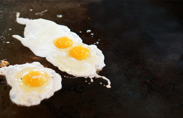 fried eggs on iron plate