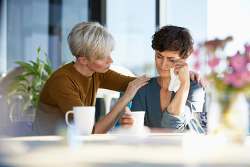 Woman consoling crying friend