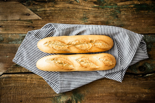 Two baguettes on kitchen towel