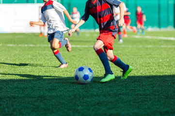 Football training soccer for kids. Boy runs kicks dribbles soccer balls. Young footballers dribble and kick football ball in game. Training, active lifestyle, sport, children activity concept 