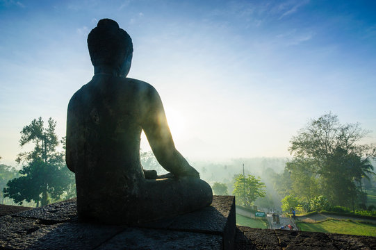 Indonesia, Java, Borobudur Temple Complex, sitting Buddha in backlight