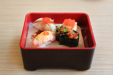 sushi set served with cold smoked on wooden table. Traditional Japanese food.