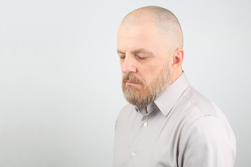 Obraz premium pensive bearded man in a shirt with your eyes closed