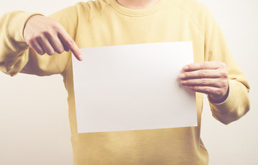 man holding a empty white paper in office