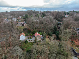 Fototapeta na wymiar Aerial view of country side area in Walloon Brabant, Belgium, Luxury wealthy villas with garden surrounded by forest during winter season.