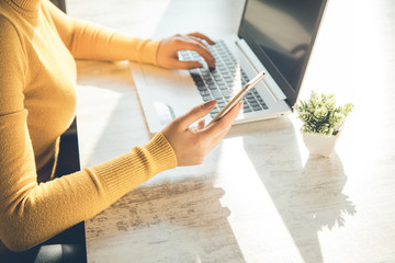woman hand phone with keyboard on desk