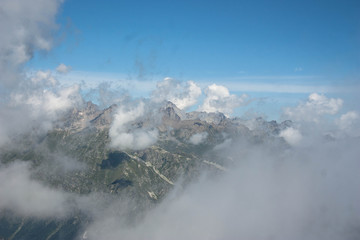 high steep mountains of the Caucasus above the clouds on a sunny day