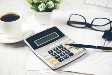 calculator with coffee and keyboard on desk