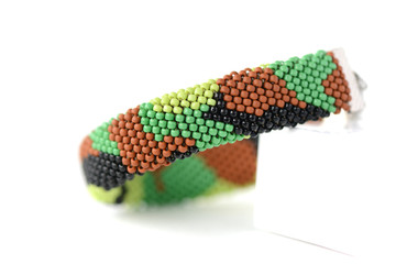 Camouflage beaded bracelet isolated on white background close up