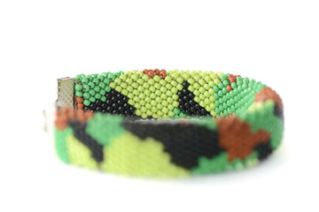 Camouflage beaded bracelet isolated on white background close up