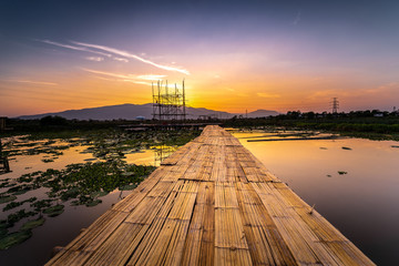 Twilight at the reservoir with bamboo bridge and reflection in sunset, Chiang Mai in Thailand