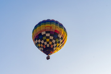 Hot air balloons flying on the blue sky during sunrise in morning..